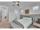 Relaxing bedroom features wainscoting, a ceiling fan, and an ensuite bathroom at 9730 E Resistance Ave, Mesa, AZ 85212