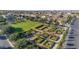 An aerial view of a neighborhood park with lush landscaping and walking paths among the residential homes at 9730 E Resistance Ave, Mesa, AZ 85212