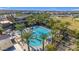 Aerial view of the community pool surrounded by palms and lounge chairs on a sunny day at 9730 E Resistance Ave, Mesa, AZ 85212