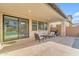 Relaxing covered patio with comfortable seating and travertine pavers, ideal for enjoying the backyard pool view at 9730 E Resistance Ave, Mesa, AZ 85212