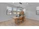 Bright dining room features a wood table, modern chandelier, and lots of natural light at 9730 E Resistance Ave, Mesa, AZ 85212