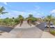 Entrance path lined with palm trees leading to a building and parking lot at 9730 E Resistance Ave, Mesa, AZ 85212