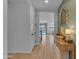 Bright entryway with wood-look tile, console table, and views of the staircase and backyard pool at 9730 E Resistance Ave, Mesa, AZ 85212