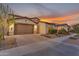 Attractive single-Gathering home boasts a two-car garage, desert landscaping, and a well-maintained exterior at 9730 E Resistance Ave, Mesa, AZ 85212