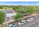 Outdoor cafe with tables and umbrellas near a quaint farm store and landscaped area at 9730 E Resistance Ave, Mesa, AZ 85212