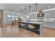 Spacious kitchen featuring an island with seating, modern pendant lighting, and stainless steel appliances at 9730 E Resistance Ave, Mesa, AZ 85212