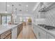 Modern kitchen with an island, stainless appliances, and a view of the dining area at 9730 E Resistance Ave, Mesa, AZ 85212