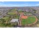 Aerial view of baseball and basketball sports fields in a park setting near a residential area at 9730 E Resistance Ave, Mesa, AZ 85212