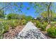 Scenic community walkway featuring lush landscaping and mature trees for a serene outdoor experience at 9730 E Resistance Ave, Mesa, AZ 85212