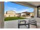 Outdoor entertaining area with an outdoor kitchen, seating, and beautiful turf at 9759 E Satellite Dr, Mesa, AZ 85212