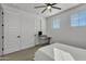 Bright bedroom featuring a ceiling fan, ample natural light, and simple décor, creating a serene atmosphere at 9759 E Satellite Dr, Mesa, AZ 85212