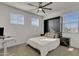 Well-lit bedroom featuring a murphy bed, a ceiling fan, and bright windows, offering comfort and versatility at 9759 E Satellite Dr, Mesa, AZ 85212