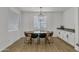 Dining room with modern table, stylish chairs, and natural light from the window at 9759 E Satellite Dr, Mesa, AZ 85212