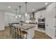 Modern kitchen with white cabinetry, stainless steel appliances, and an island with bar seating at 9759 E Satellite Dr, Mesa, AZ 85212