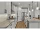 Beautiful kitchen with white cabinets, quartz countertops, subway tile backsplash, and stainless appliances at 9759 E Satellite Dr, Mesa, AZ 85212