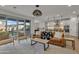 Open concept living room with modern furnishings, bright lighting, and wood floors at 9759 E Satellite Dr, Mesa, AZ 85212