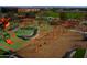 Modern community playground with slides, swings, and climbing frames set on green and mulch surfaces at 9759 E Satellite Dr, Mesa, AZ 85212