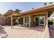 Outdoor covered patio space features multiple seating areas for entertaining, enjoying tranquil backyard views at 9837 E Michigan Ave, Sun Lakes, AZ 85248