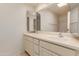 Bathroom vanity with double sinks and large mirror at 9837 E Michigan Ave, Sun Lakes, AZ 85248