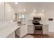 Bright kitchen with stainless steel appliances, white cabinets, and light countertops at 9837 E Michigan Ave, Sun Lakes, AZ 85248