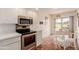 Open kitchen and dining area featuring tile floors and stainless steel appliances at 9837 E Michigan Ave, Sun Lakes, AZ 85248