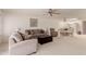 Cozy living room featuring plush carpeting, a ceiling fan, and comfortable furniture at 9837 E Michigan Ave, Sun Lakes, AZ 85248