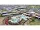 Aerial view of resort-style community pool, tennis courts, and clubhouse, showcasing recreational amenities and neighborhood layout at 10049 E Topaz Ave, Mesa, AZ 85212