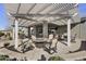 Inviting backyard patio with pergola, fire pit, and comfortable seating, perfect for outdoor gatherings at 10049 E Topaz Ave, Mesa, AZ 85212