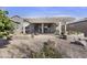 Large backyard patio with a pergola, dining area, and inviting landscaping perfect for relaxation at 10049 E Topaz Ave, Mesa, AZ 85212