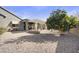Inviting backyard featuring drought-tolerant landscaping, a large citrus tree, and a shaded patio at 10049 E Topaz Ave, Mesa, AZ 85212