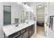 Bathroom featuring double sinks, dark wood cabinetry and ample storage space at 10049 E Topaz Ave, Mesa, AZ 85212