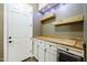 Charming butler's pantry featuring floating shelves, wooden counters, white cabinets and a wine fridge at 10049 E Topaz Ave, Mesa, AZ 85212