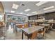 This craft room is designed for all kinds of hobbies with tables, chairs, and ample counter space at 10049 E Topaz Ave, Mesa, AZ 85212