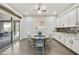 Bright dining area with sliding door access, ceiling fan, natural light, and built-in cabinets at 10049 E Topaz Ave, Mesa, AZ 85212