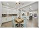 Open floorplan with dining area featuring wooden table, light blue chairs, and kitchen access at 10049 E Topaz Ave, Mesa, AZ 85212