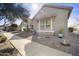 Lovely, sun-drenched gray home featuring well maintained landscaping, and a beautiful rock accent on the facade at 10049 E Topaz Ave, Mesa, AZ 85212