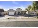 Charming single-story home with a well-manicured front yard and a two-car garage in a suburban neighborhood at 10049 E Topaz Ave, Mesa, AZ 85212
