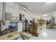 Functional garage area with utility setup, shelving for storage, and organized boxes at 10049 E Topaz Ave, Mesa, AZ 85212