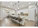 Kitchen and dining area with island seating, stainless steel appliances, and views into the dining space at 10049 E Topaz Ave, Mesa, AZ 85212