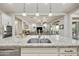 Open kitchen view, showcasing granite counters, stainless steel sink, and spacious open layout to living areas at 10049 E Topaz Ave, Mesa, AZ 85212