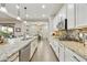 Well-lit kitchen showcases stainless steel appliances, granite countertops, tile backsplash, and center island at 10049 E Topaz Ave, Mesa, AZ 85212