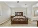 Serene main bedroom featuring a comfortable bed, bedside tables, and windows adorned with shutters at 10049 E Topaz Ave, Mesa, AZ 85212