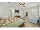 Spacious main bedroom with a king-size bed, a cozy seating area, and a large window providing ample light at 10049 E Topaz Ave, Mesa, AZ 85212