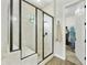 New shower features a glass enclosure, shower bench, and a door to a closet at 10049 E Topaz Ave, Mesa, AZ 85212