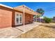 Relax on this covered back patio with brick accents and convenient access to the home's interior via glass paneled doors at 1007 W 5Th St, Mesa, AZ 85201