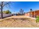 Enjoy this home's spacious backyard with mature trees, a convenient storage shed, and a covered patio for outdoor relaxation at 1007 W 5Th St, Mesa, AZ 85201
