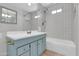 Well-lit bathroom with a single sink vanity, complemented by white tile walls and a shower-tub combination at 1007 W 5Th St, Mesa, AZ 85201