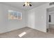 Bright bedroom offers neutral carpet, a window, a closet, and a ceiling fan at 1007 W 5Th St, Mesa, AZ 85201