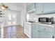 Charming kitchen with light blue cabinets, white appliances, and tile flooring at 1007 W 5Th St, Mesa, AZ 85201