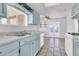 Bright kitchen featuring pale blue cabinets, white appliances, and tile flooring, providing a cozy cooking space at 1007 W 5Th St, Mesa, AZ 85201
